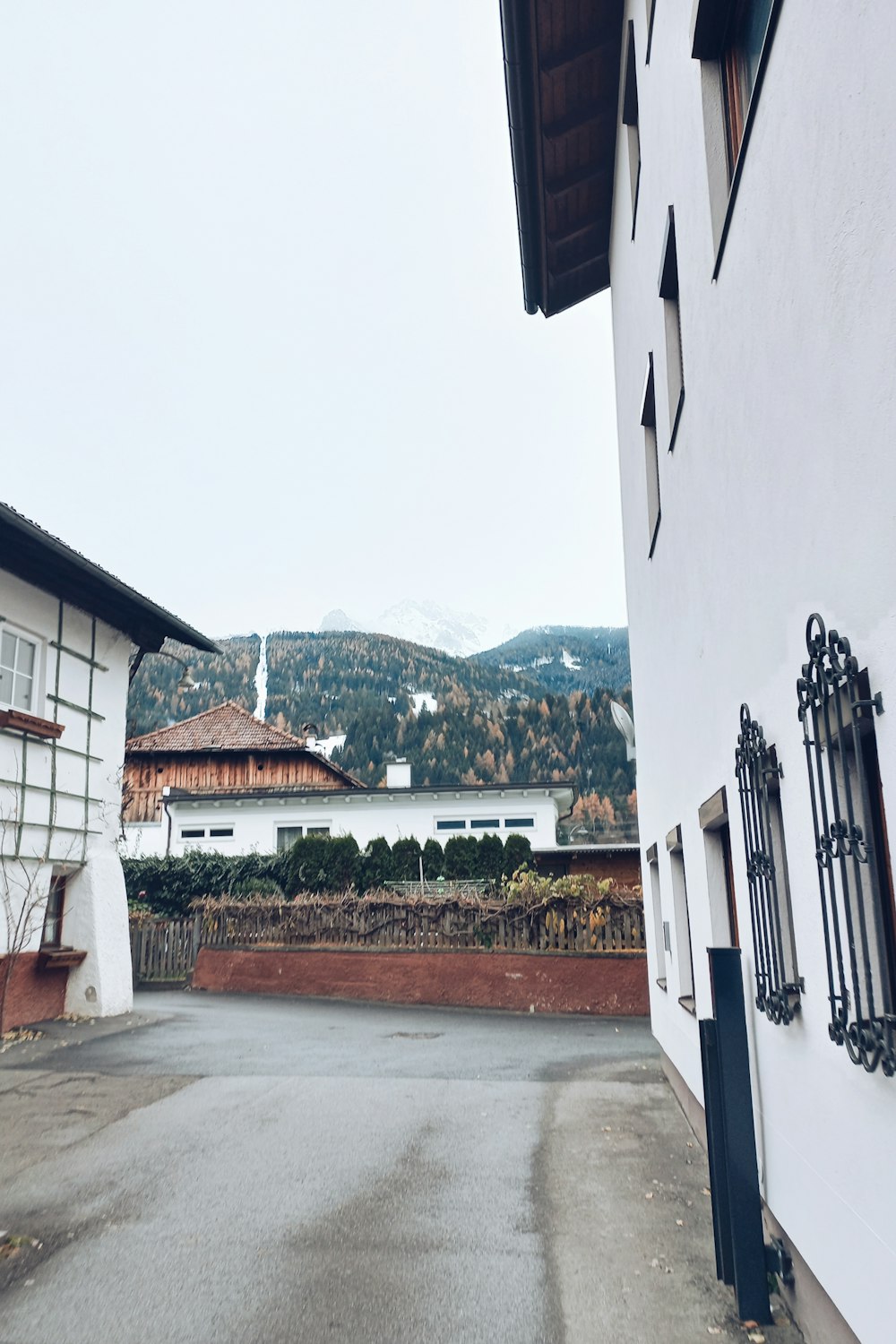 a white building with a mountain in the background