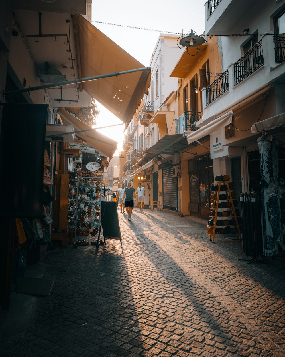 a person walking down a street next to tall buildings