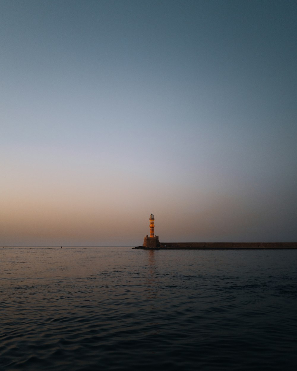 a light house in the middle of a body of water