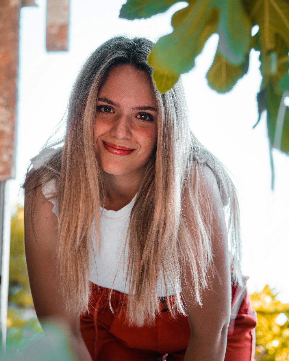 a woman with long blonde hair smiling at the camera