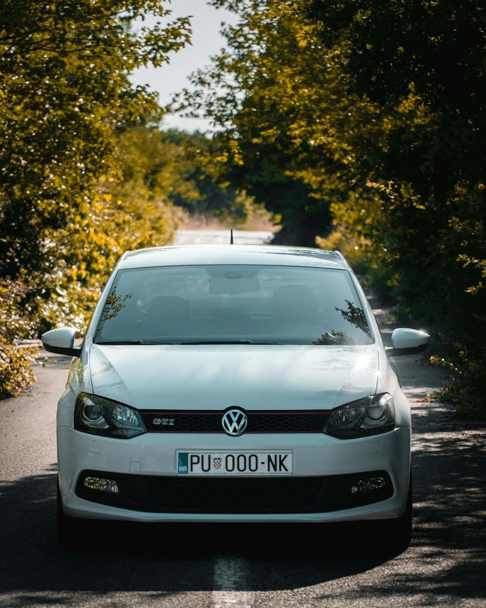 a white car parked on the side of a road