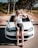 a woman sitting on the hood of a car