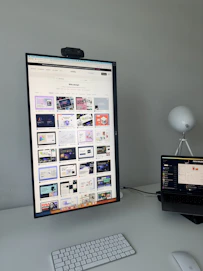 A sleek workspace with a laptop displaying a modern personal brand website design.