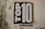 A textured wall features a large poster with the words 'TOP 10' in bold black and white lettering. Below the main text, a smaller phrase reads 'solutions for the common good'.
