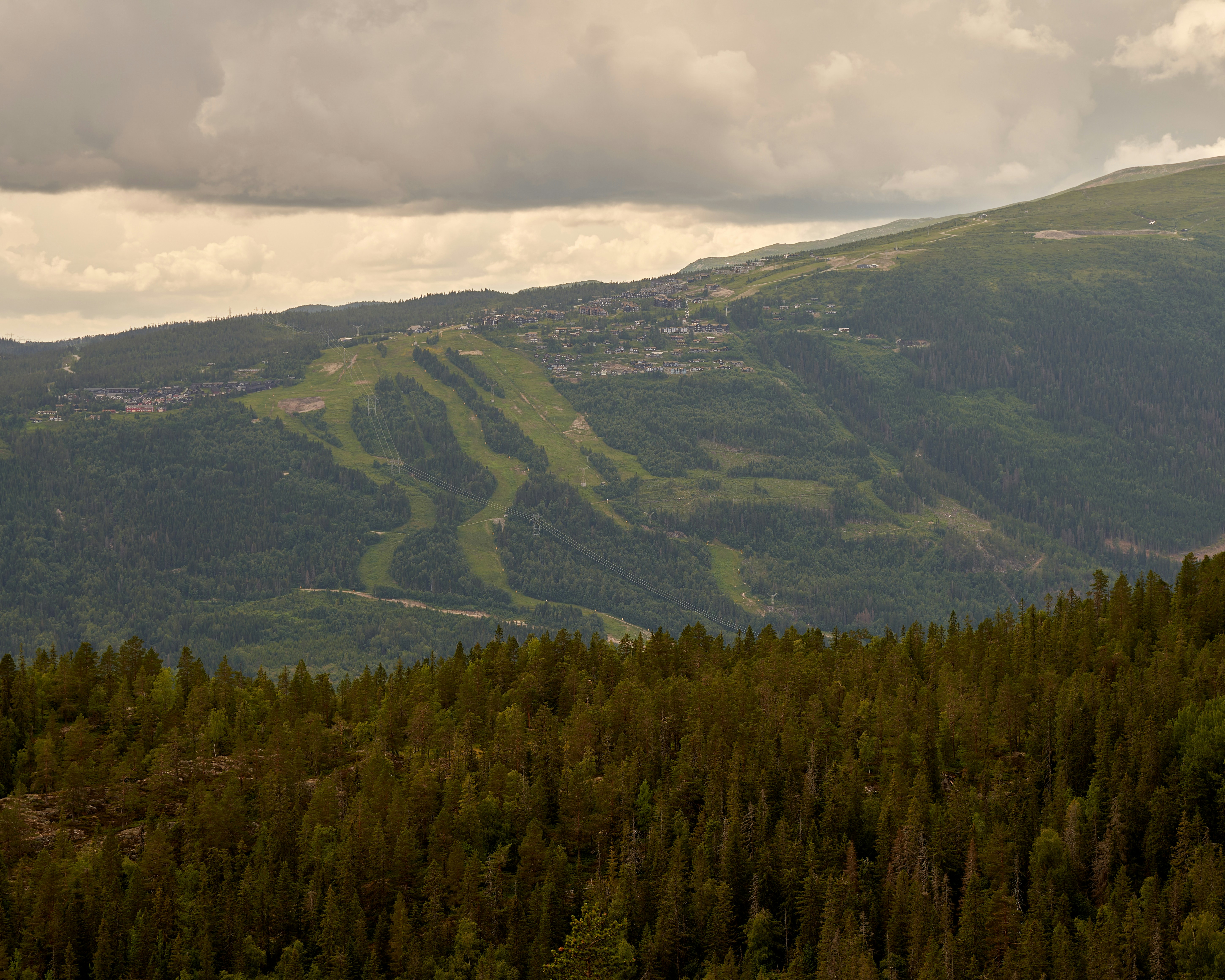 a view of a mountain with a ski slope in the distance