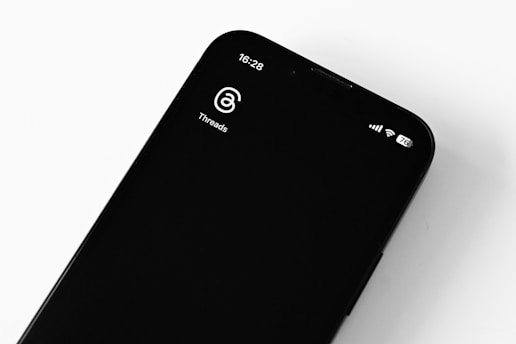 A smartphone displaying the Meshtastic app interface with a map and message threads.