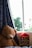 A cozy living room scene featuring a child hugging a realistic racoon plushie.