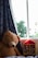 A cozy living room scene featuring a child hugging a realistic racoon plushie.
