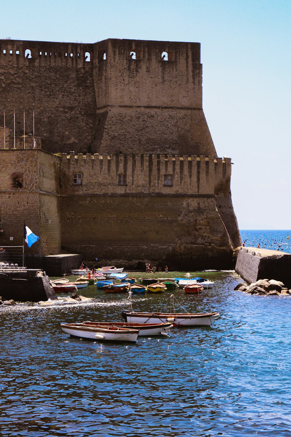 a group of small boats floating on top of a body of water