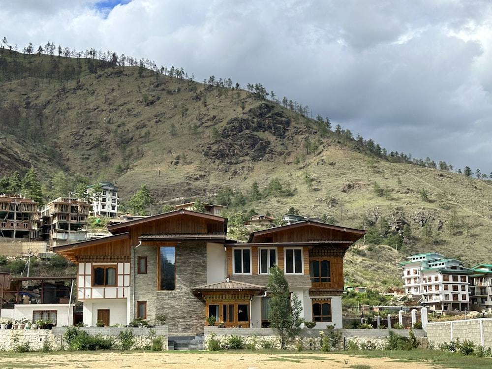 a large house sitting in the middle of a lush green hillside