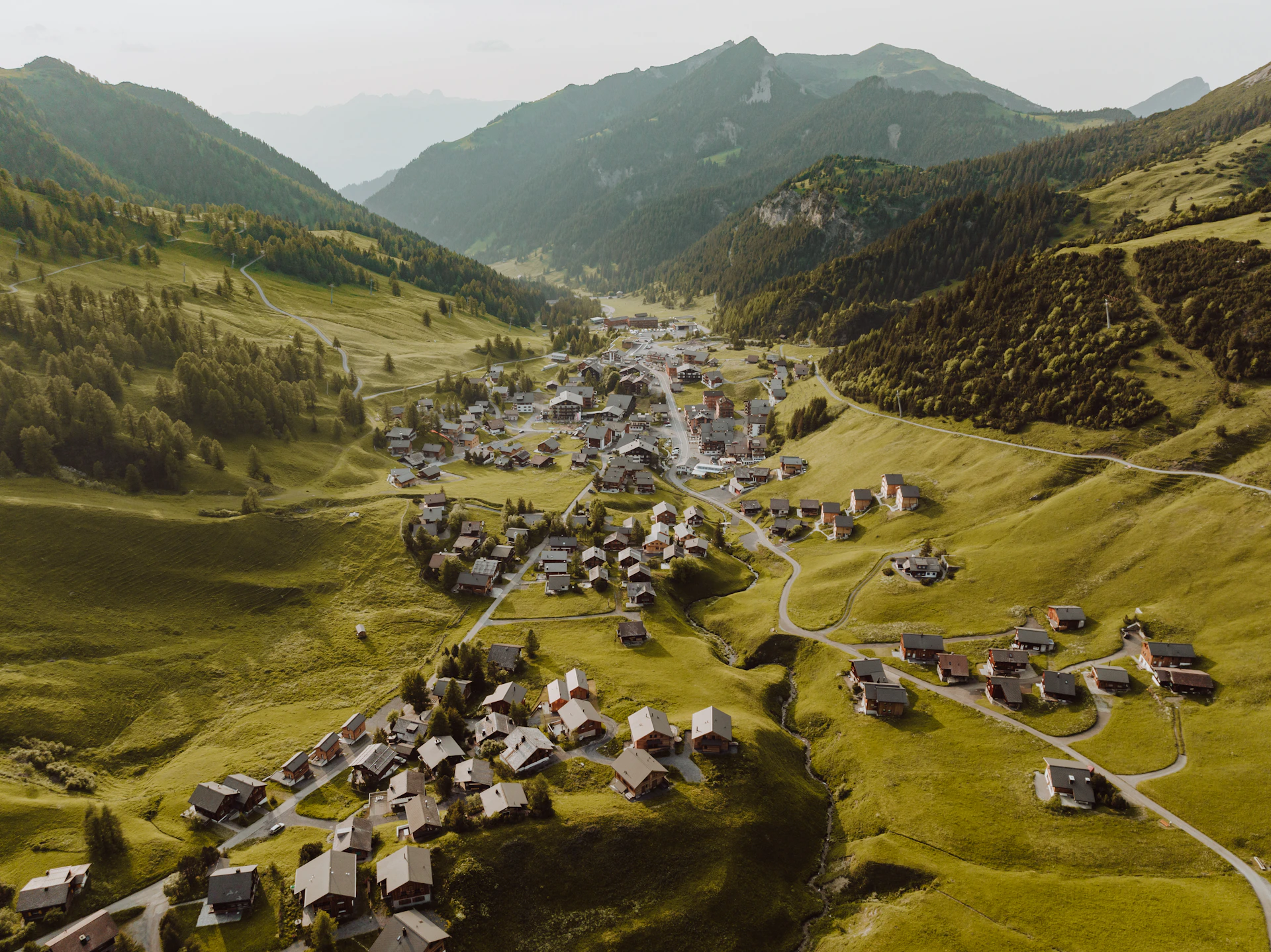 an aerial view of a village in the mountains