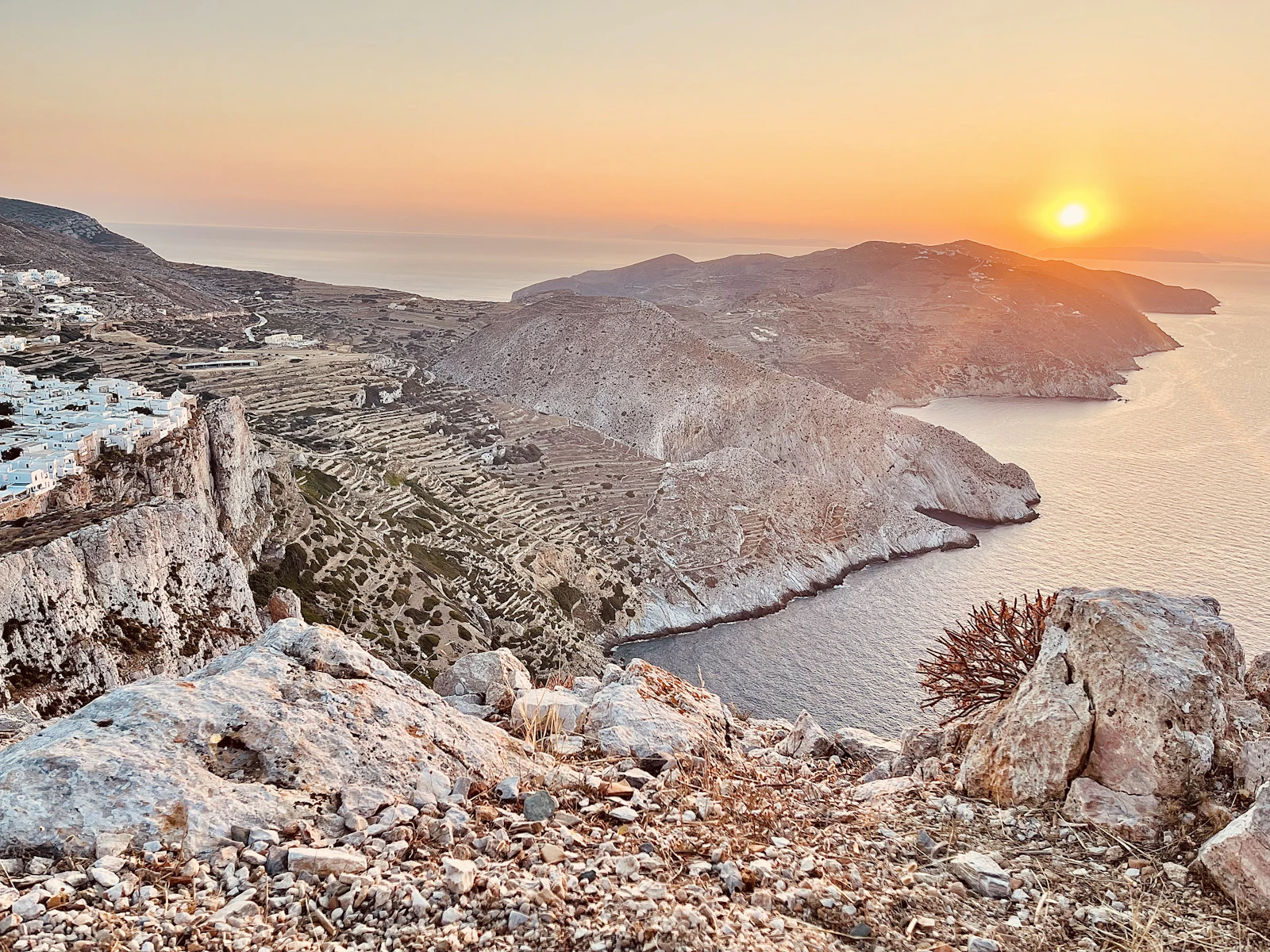 The sun setting over the ridge and the sea at Folegandros