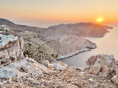 The sun setting over the ridge and the sea at Folegandros