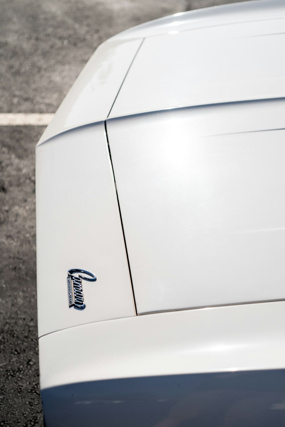 a white sports car parked in a parking lot