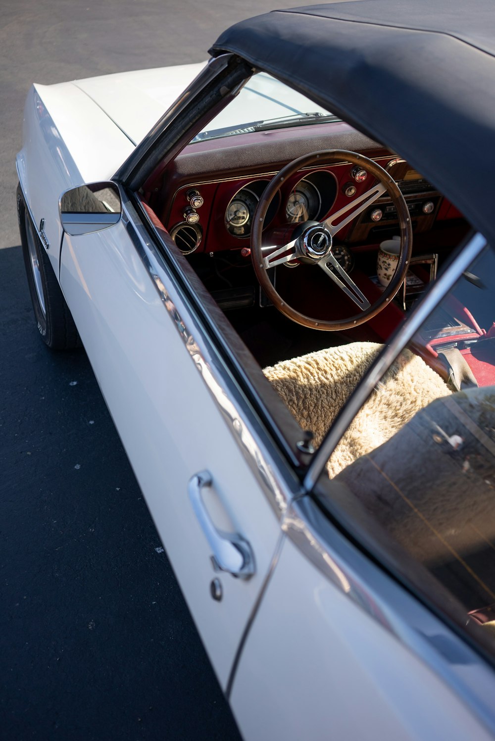 the interior of a classic car with a sheep in the driver's seat