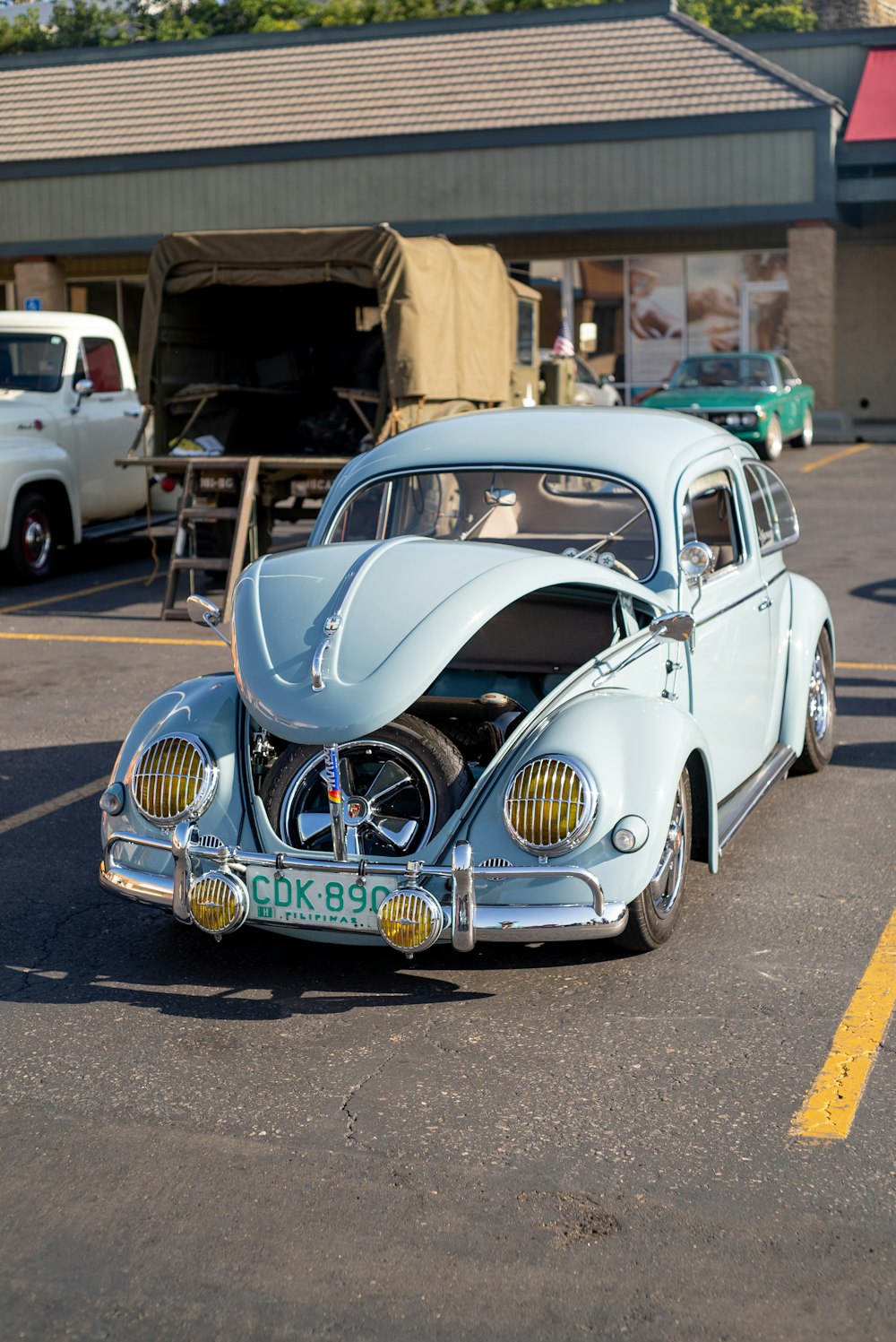 an old car is parked in a parking lot