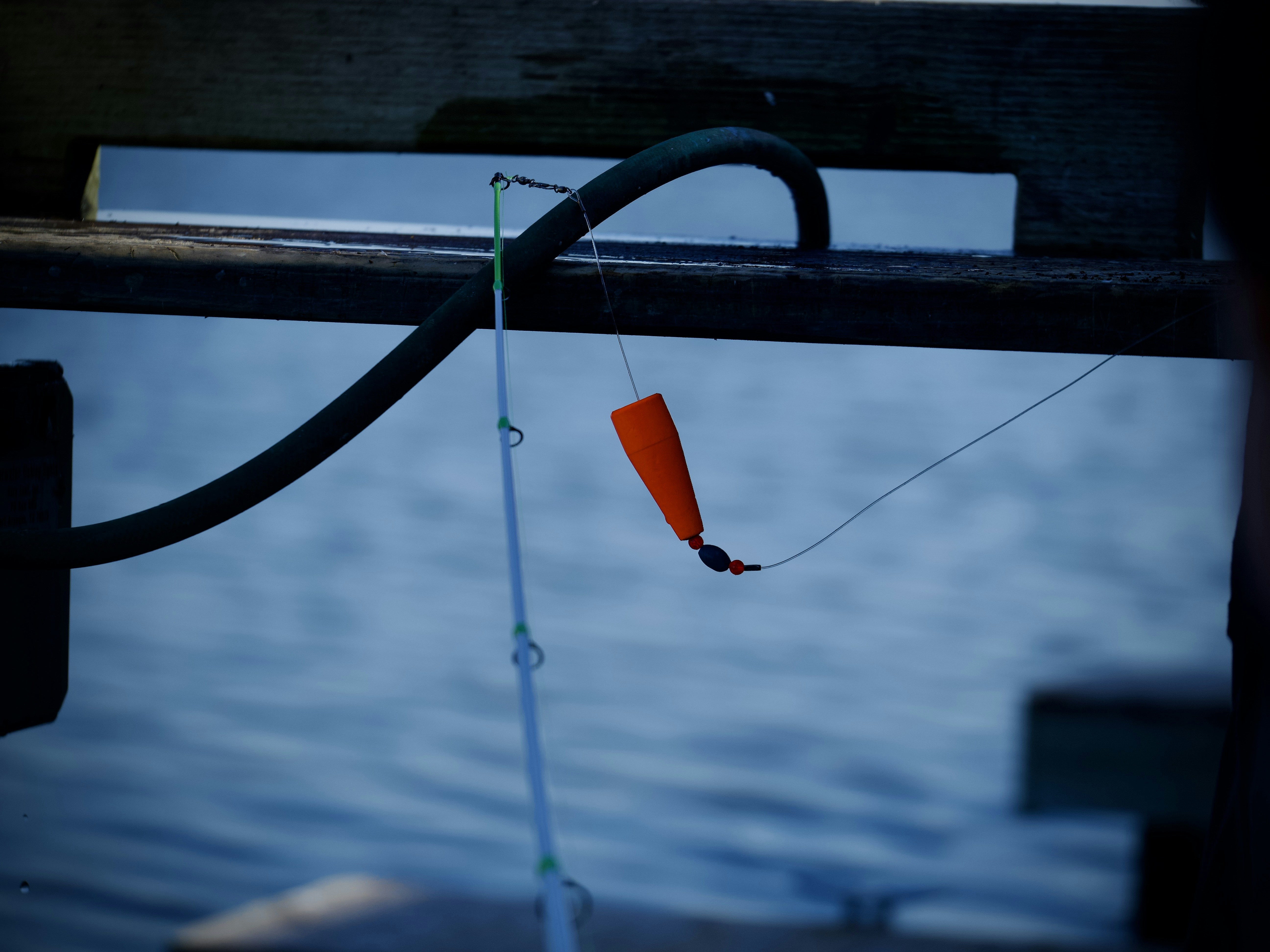 a fishing rod attached to a boat near a body of water