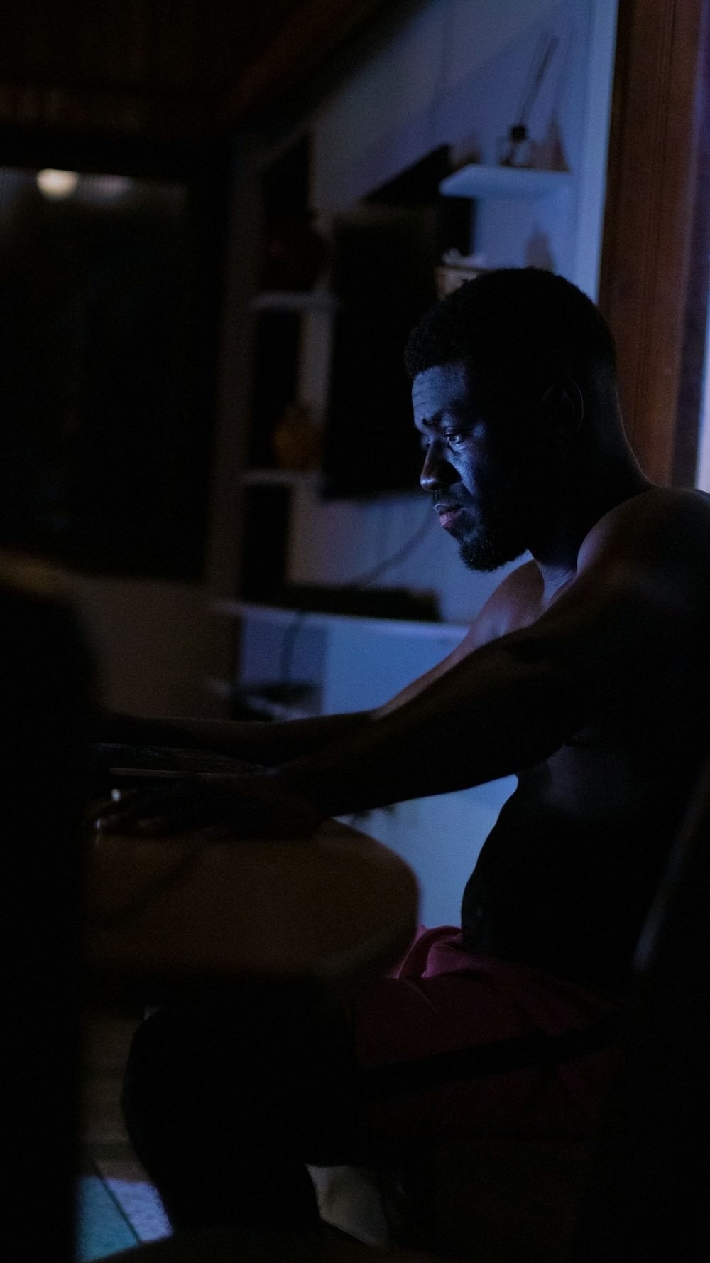 a man sitting in a chair in a dark room