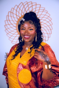 A vibrant photo of a confident Nigerian woman wearing a flowing contemporary African dress, smiling against a city backdrop.