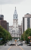 a city street with a clock tower in the background