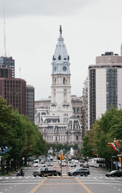 a city street with a clock tower in the background