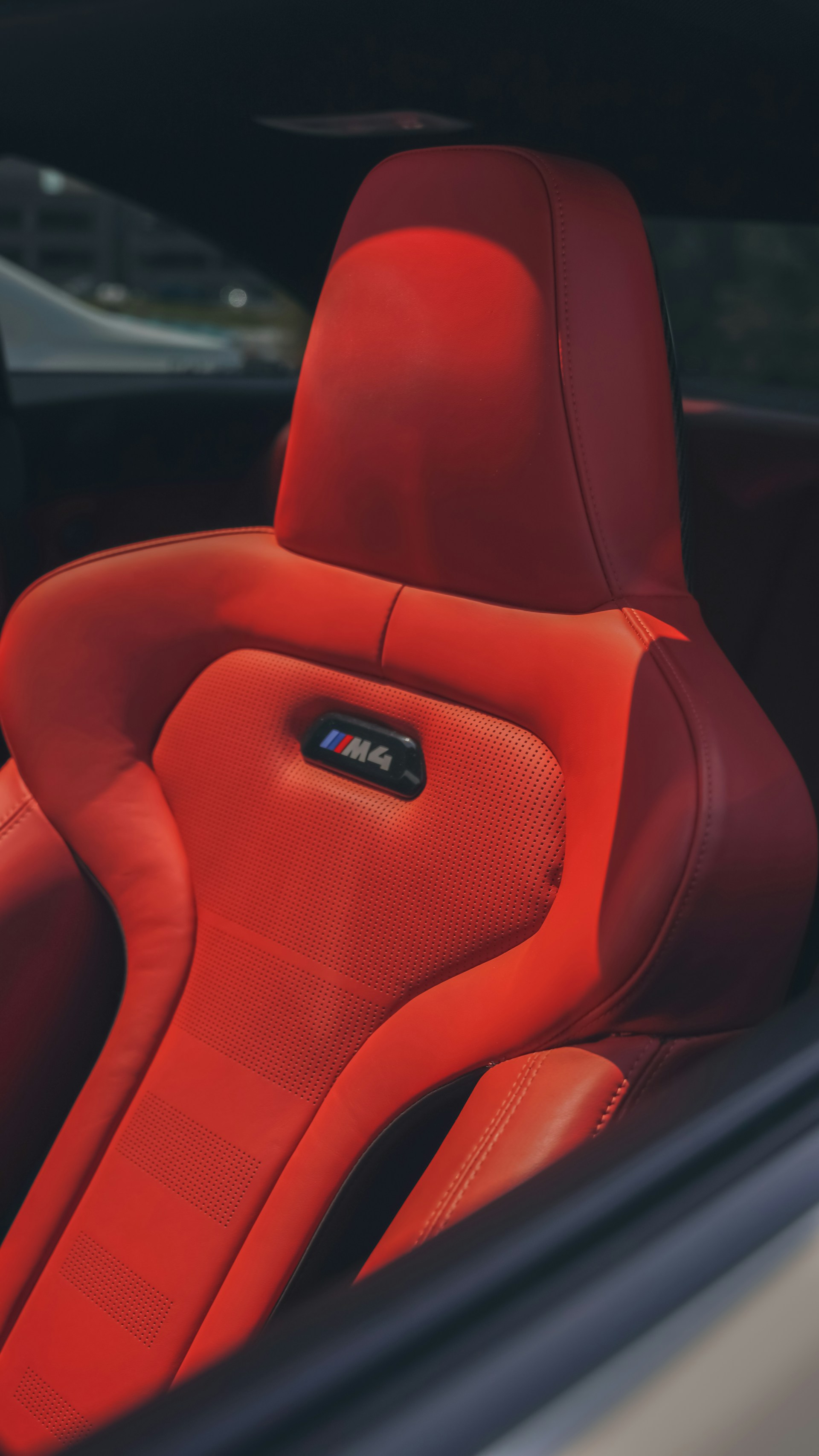the interior of a car with a red leather seat