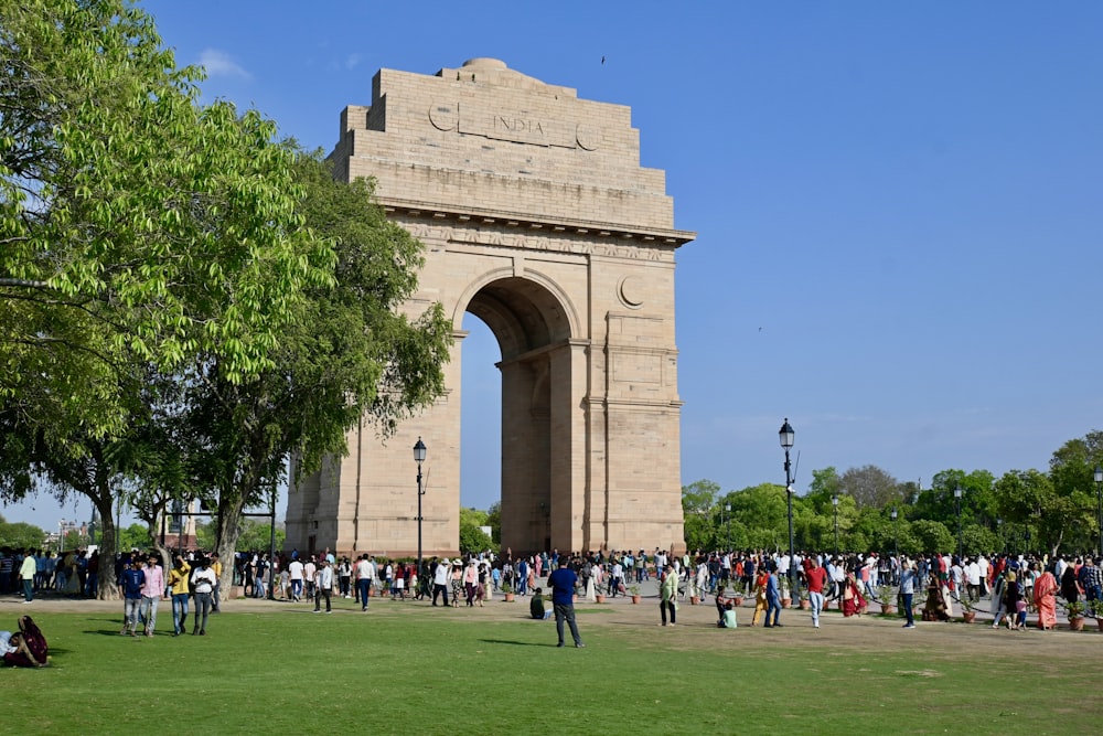 a large group of people standing around a monument