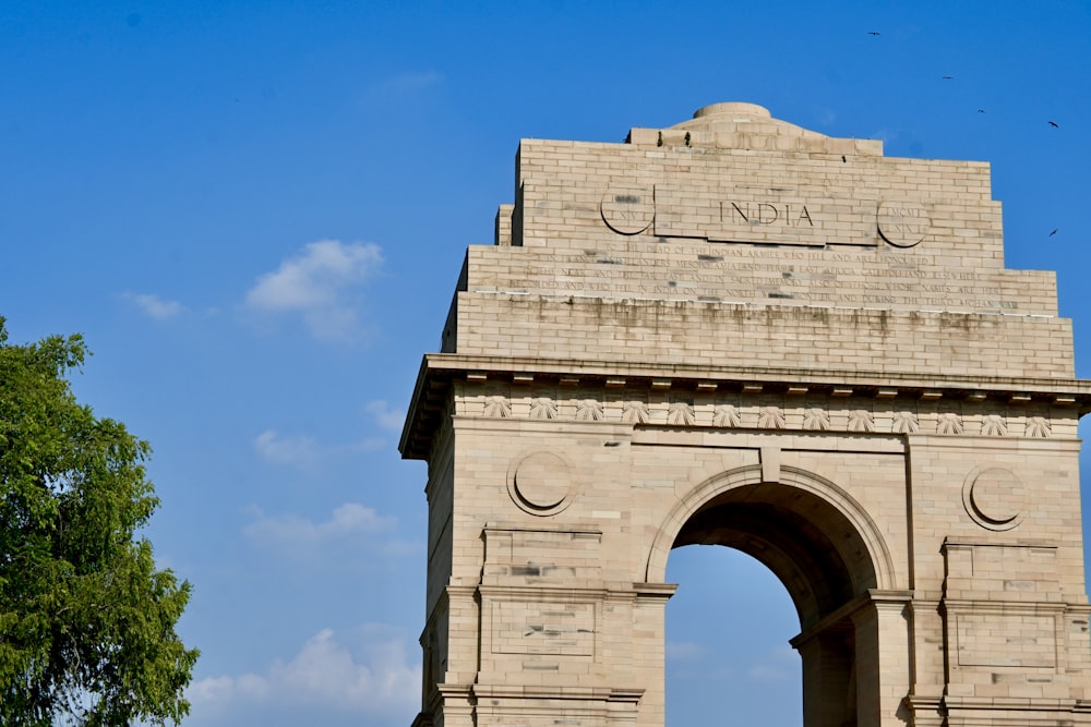 a large stone arch with a clock on top of it