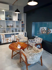 Comfortable seating area inside a triple room with Mediterranean color palette accents.