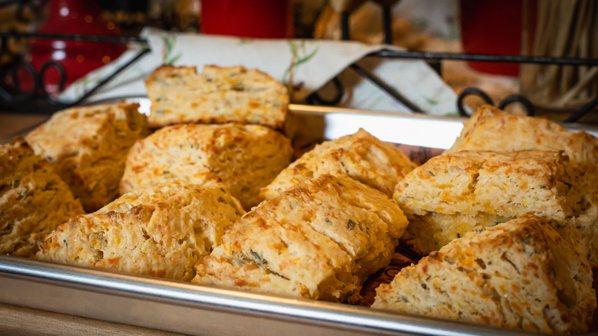 Golden cheddar biscuits on a baking pan
