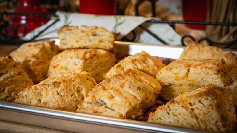 Golden cheddar biscuits on a baking pan