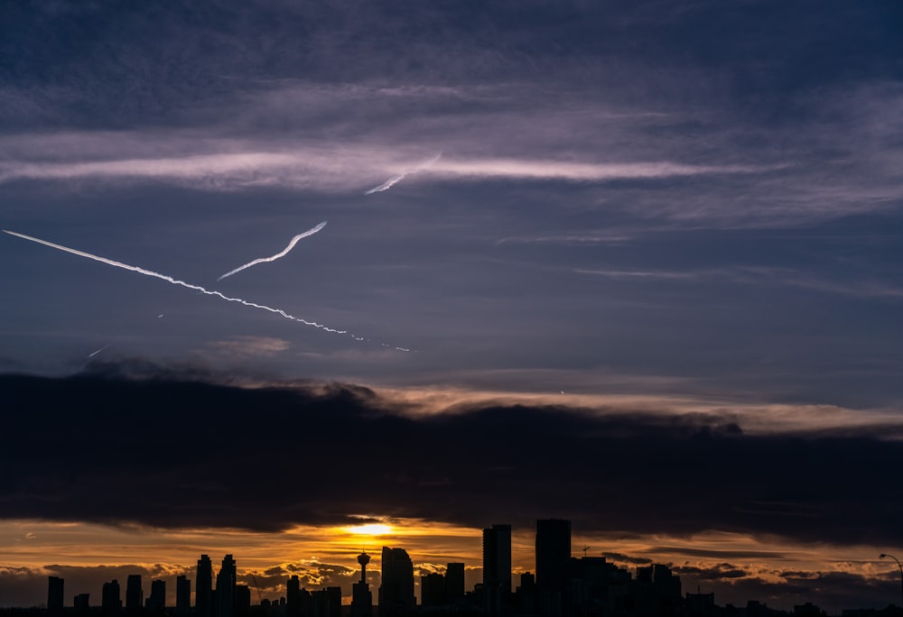 an airplane is flying in the sky over a city