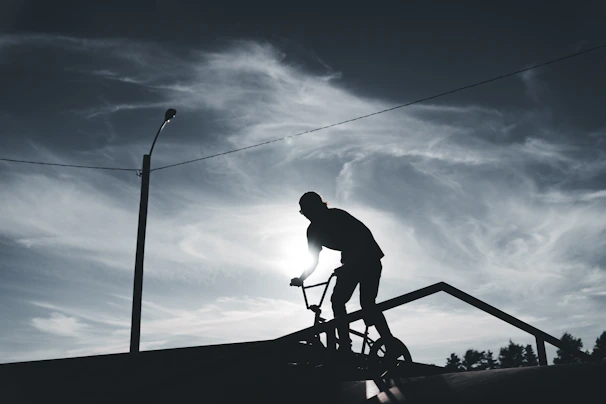 Urban BMX rider launching off a ramp at sunset in Hermosillo.