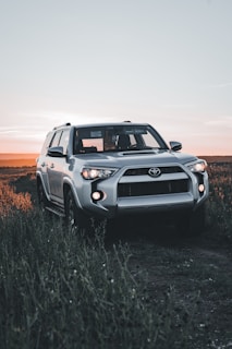 A patrol vehicle parked near a quiet country road at sunset, symbolizing vigilance.