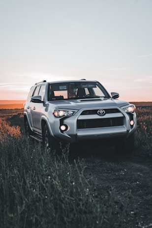 A patrol vehicle parked near a quiet country road at sunset, symbolizing vigilance.