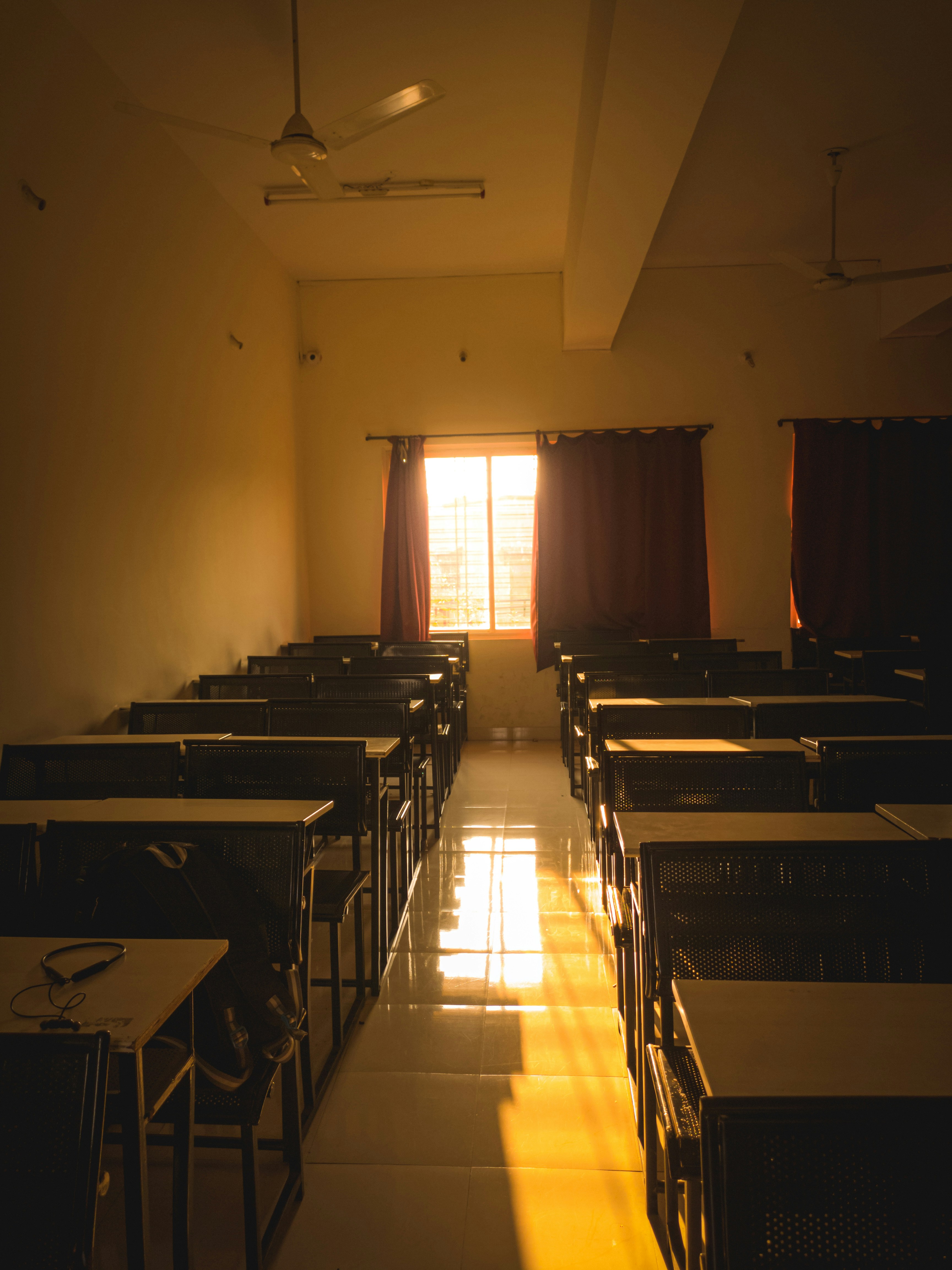 a room filled with tables and chairs next to a window