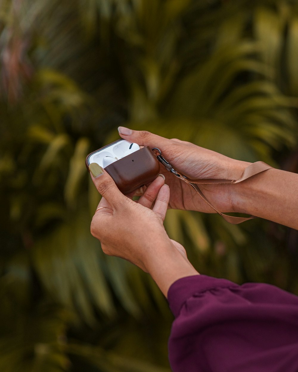 a person holding a cell phone in their hand