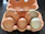 Colorful egg cartons stacked neatly with a cheerful delivery box in a cozy home setting.
