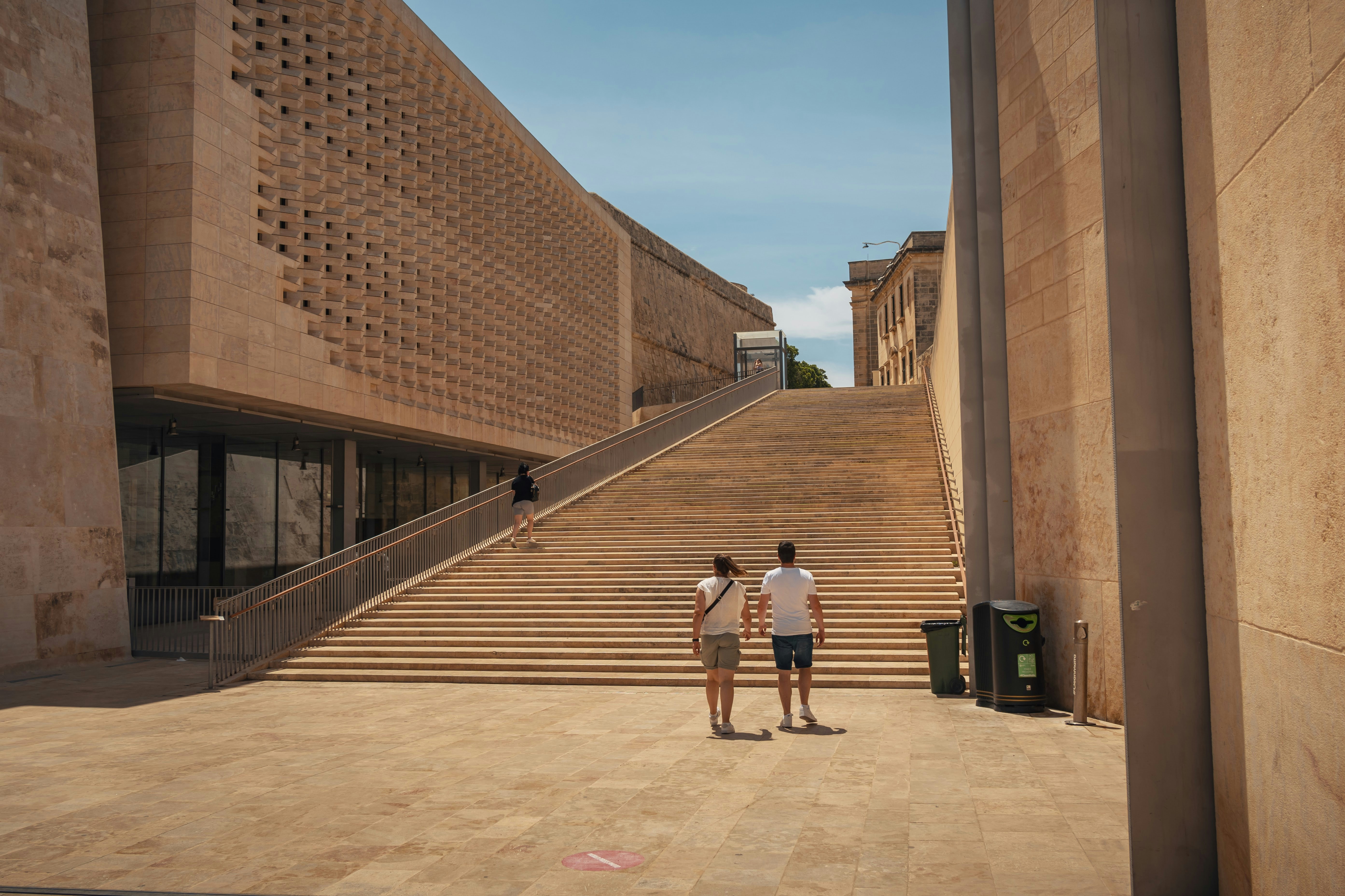 a couple of people standing in front of a building, 