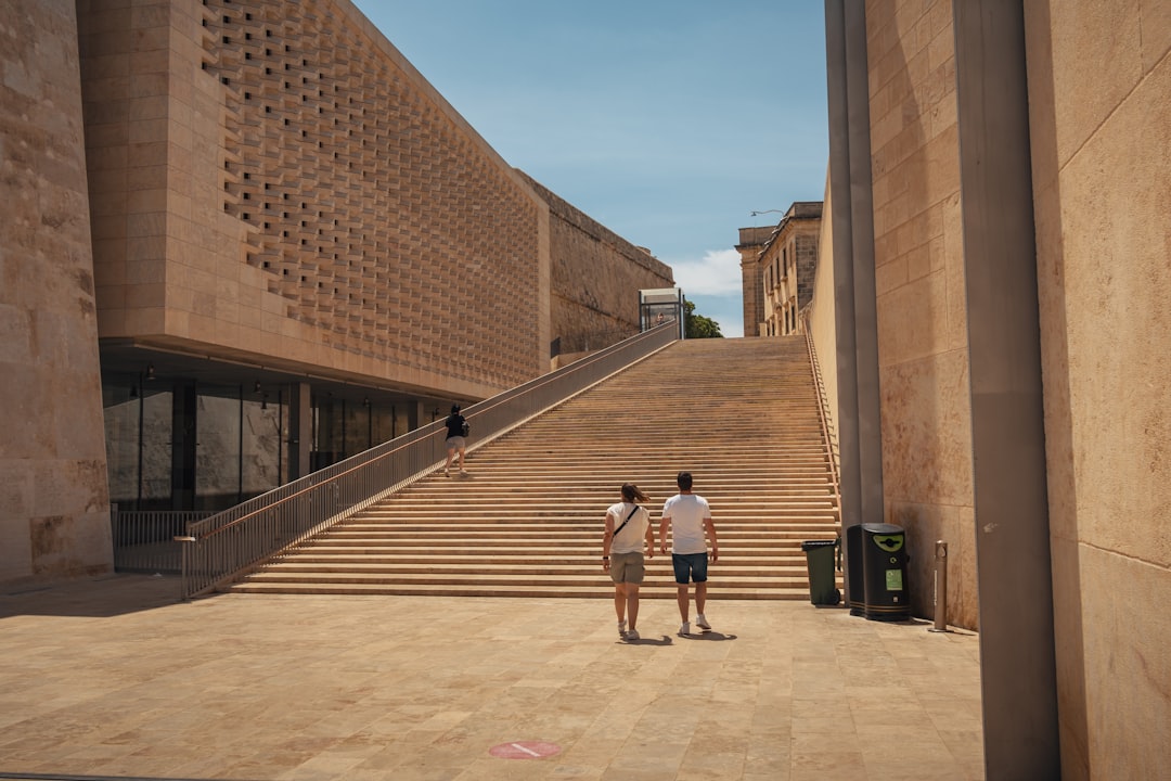 a couple of people standing in front of a building,