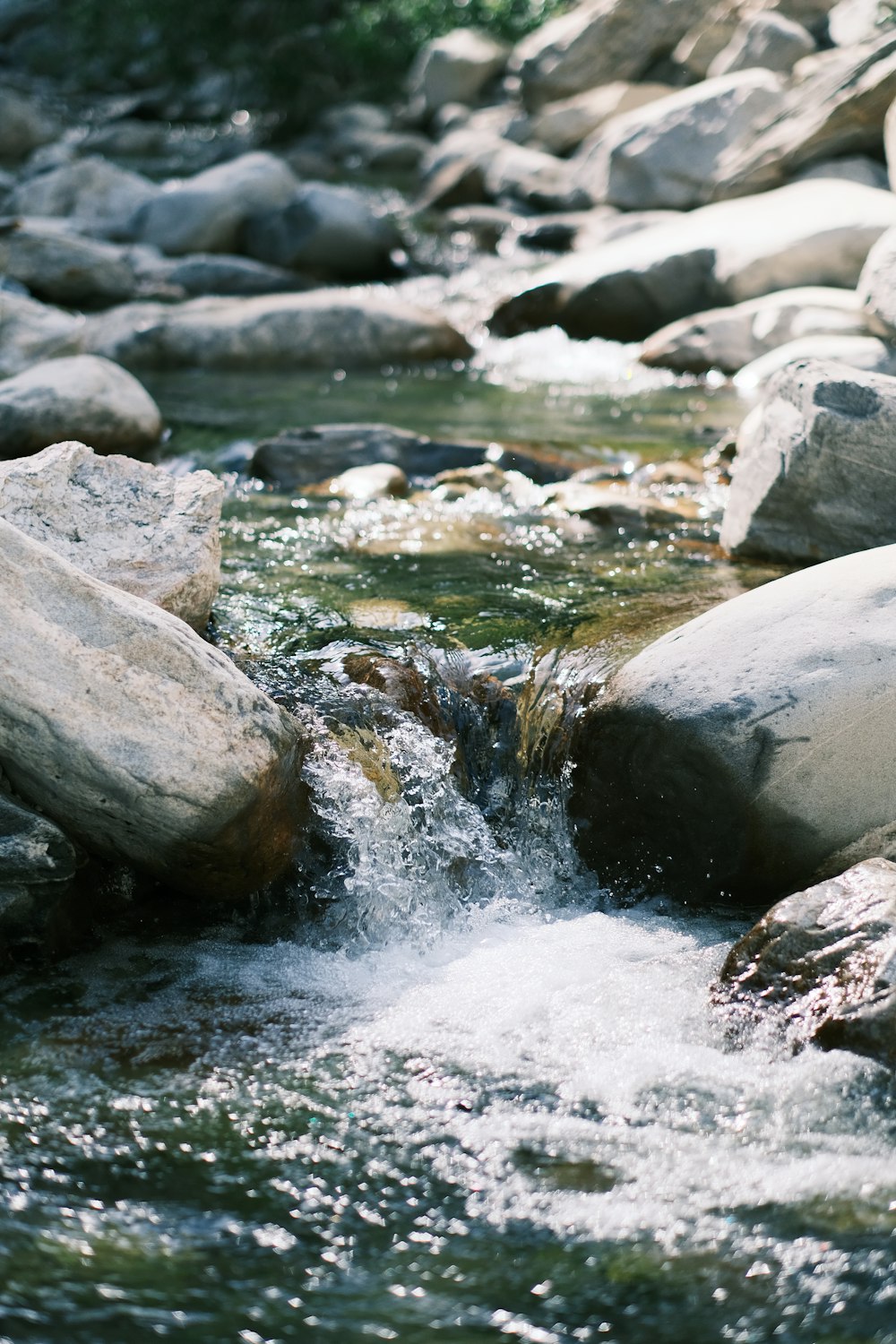 a stream of water running over rocks in a stream