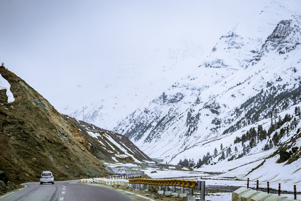 a car driving down a snowy mountain road