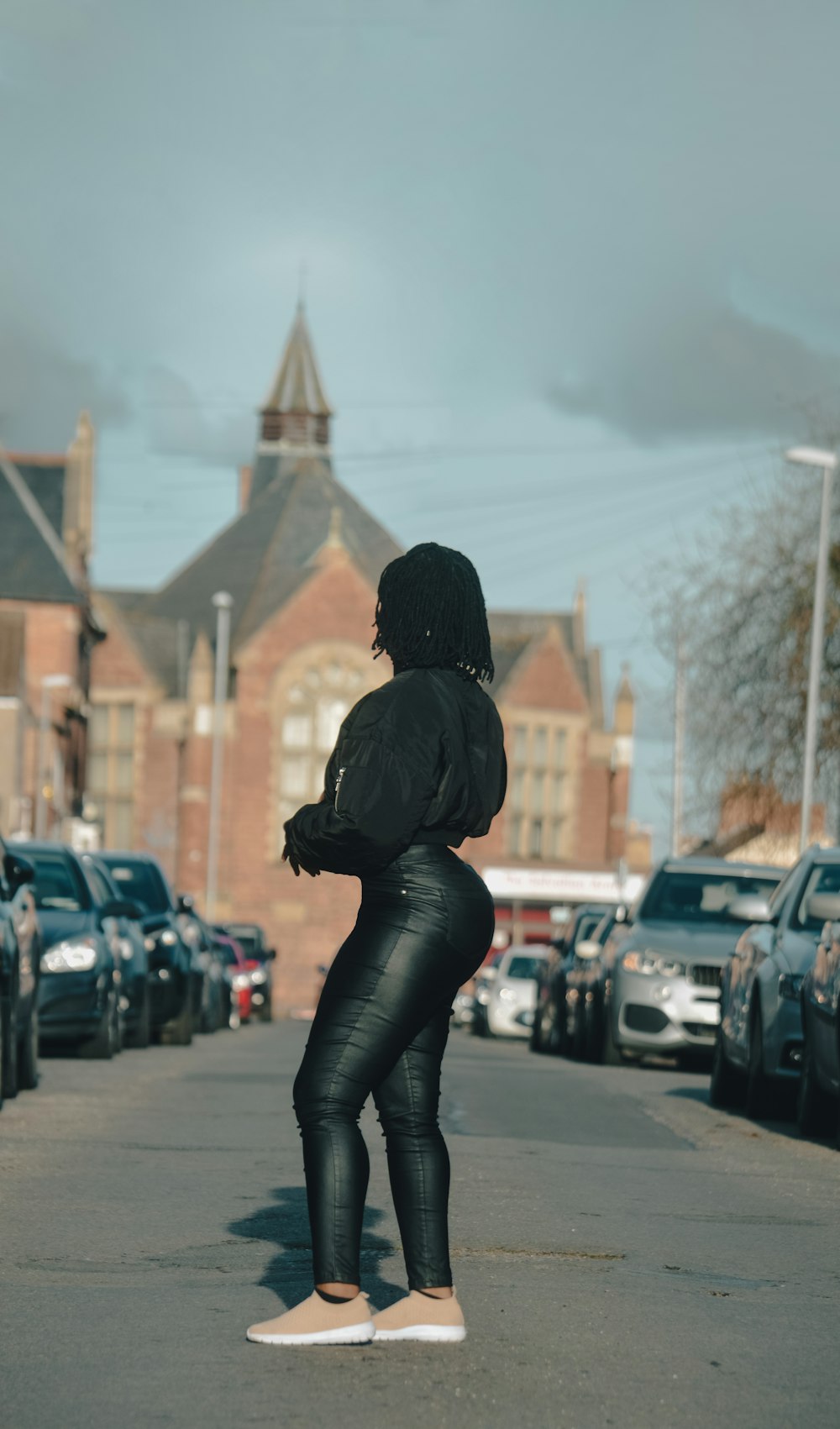 a woman standing on a skateboard on a city street