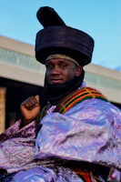 a man in a colorful outfit with a hat on his head