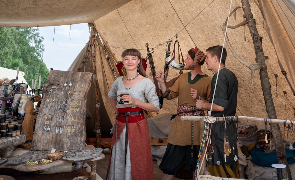 a group of people standing around a tent