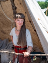 a woman standing in front of a teepee