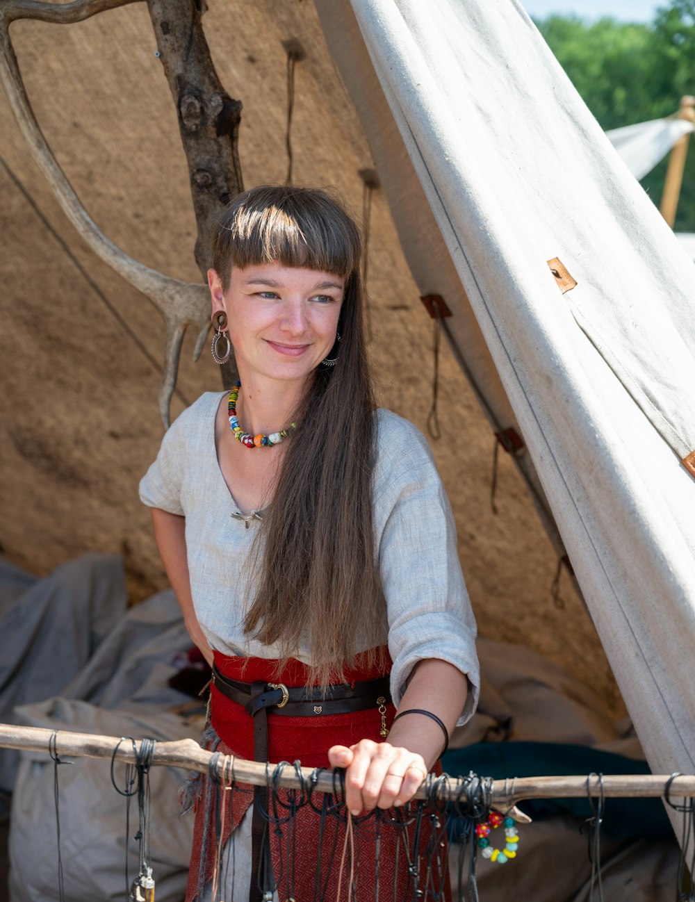 Una mujer parada frente a un tipi