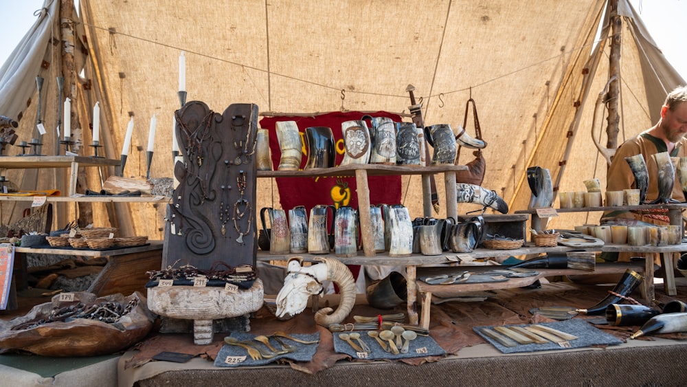 a man standing in front of a table filled with assorted items