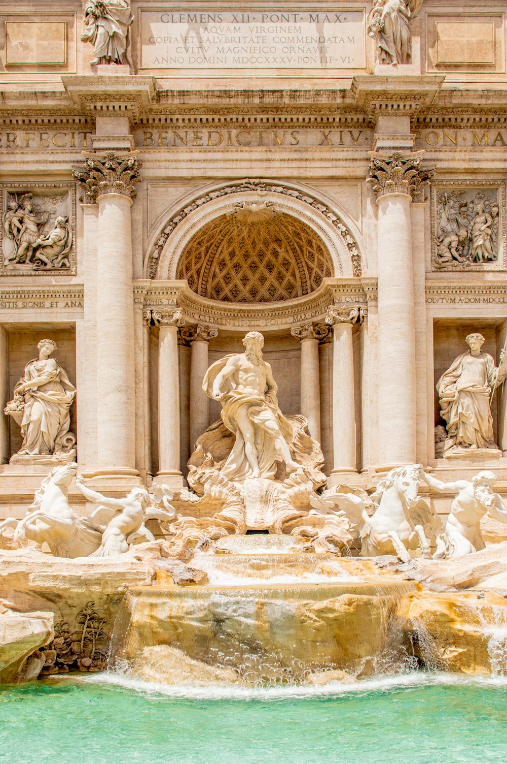 a water fountain with statues on the sides of it