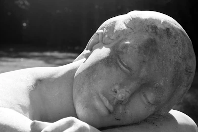 Gentle hands resting on a smooth stone, symbolizing relaxation and stress relief.